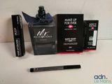 mascara, mascara tube, and mascara brush sitting on a table