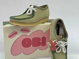 pair of children ' s shoes in a box on a white surface