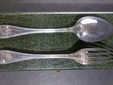 two spoons and a spoon on a green cloth