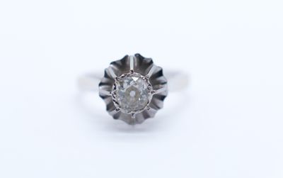 a close up of a diamond ring on a white surface