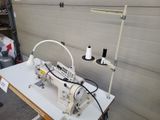 an image of a sewing machine on a table in a garage