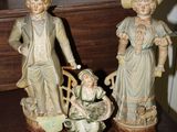 two figurines that are sitting on a table