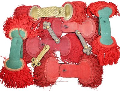 a lot of red and green dog toys on a white surface