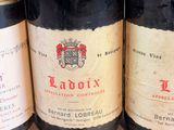 three bottles of wine are lined up on a table