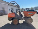 a small tractor with a dumper attached to it ' s back