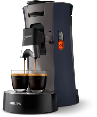 a close up of a coffee maker with two cups of coffee