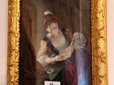 un tableau représentant une femme en train de lire un livre, dans un cadre doré