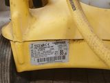 a yellow machine with a hose attached to it ' s side