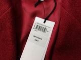 a close up of a red jacket with a tag on it