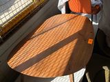 a wooden table and chair in a room with a window