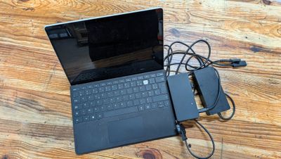 a laptop computer sitting on top of a wooden table