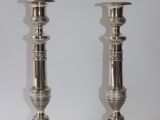 pair of silver candlesticks on a white background
