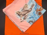 a close up of an orange bag with a picture of a sea otter on it