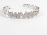 a close up of a silver bracelet on a white surface