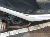 a motor scooter that is parked on the side of the street
