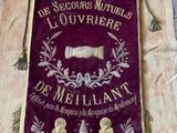 an old banner hanging on a wall with a bell hanging from it ' s side