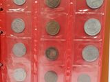 a red book with a bunch of coins in it