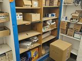 boxes and boxes are stacked on the shelves in a room
