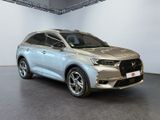 a silver car parked in a room with a white wall