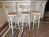 three stools sitting in front of a counter in a kitchen