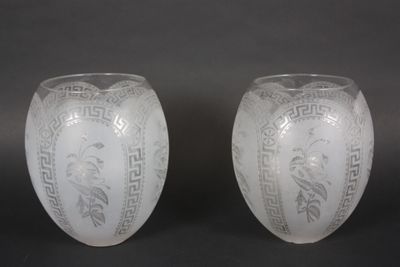 une paire de vases blancs ornés de motifs sur fond noir
