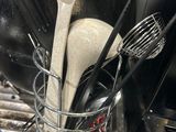 many utensils and spoons in a basket on the kitchen sink