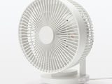 a small white fan sitting on top of a white table
