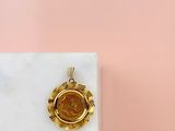 an image of a gold coin sitting on top of a marble block