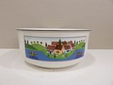a white bowl with a picture of a village on it