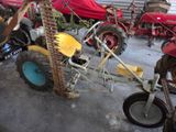 many different types of tractors parked in a garage