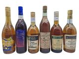 several bottles of alcohol are lined up on a white surface