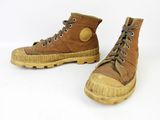 pair of brown boots with brown laces on them on a white surface