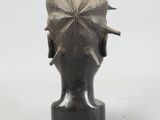 sculpture of a woman ' s head with a flower in her hair