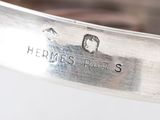 a close up of a silver bracelet with a name on it
