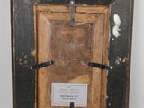 an old picture frame with a cross hanging from it ' s side