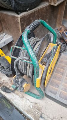 a hose that is sitting on the ground next to a pile of tires