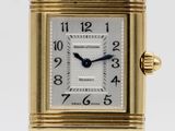 an image of a close up of a wrist watch with a gold case