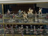 many figurines of soldiers in a glass case