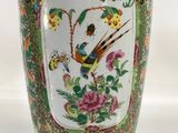 a vase with a bird on it sitting on a table
