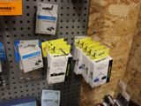many boxes of electrical components on the wall in the store