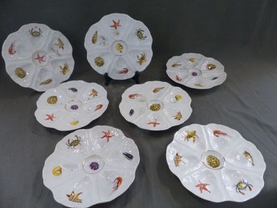 six assiettes blanches ornées de motifs différents, posées sur une table