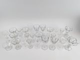 a lot of empty glasses on the table next to a vase