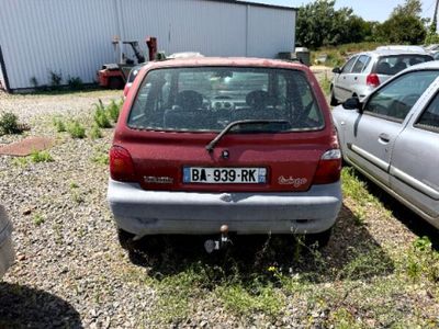 a red car that is parked next to a silver car