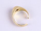 an image of a gold ring on a white surface
