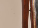 a mirror on a stand with a baseball bat on top of it