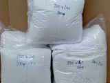 several bags of toilet paper are stacked on top of a cardboard box