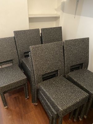 four chairs and a table in a room with wood flooring
