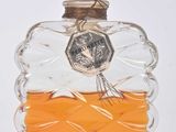 a glass bottle with an orange liquid inside of it