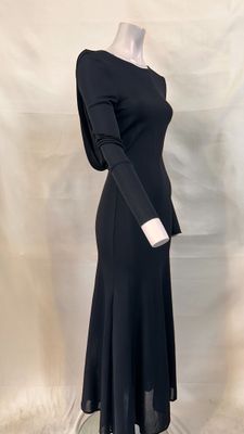 the dress is black and has long sleeves and a long skirt