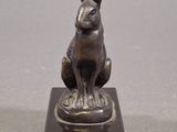 a statue of a rabbit sitting on top of a base